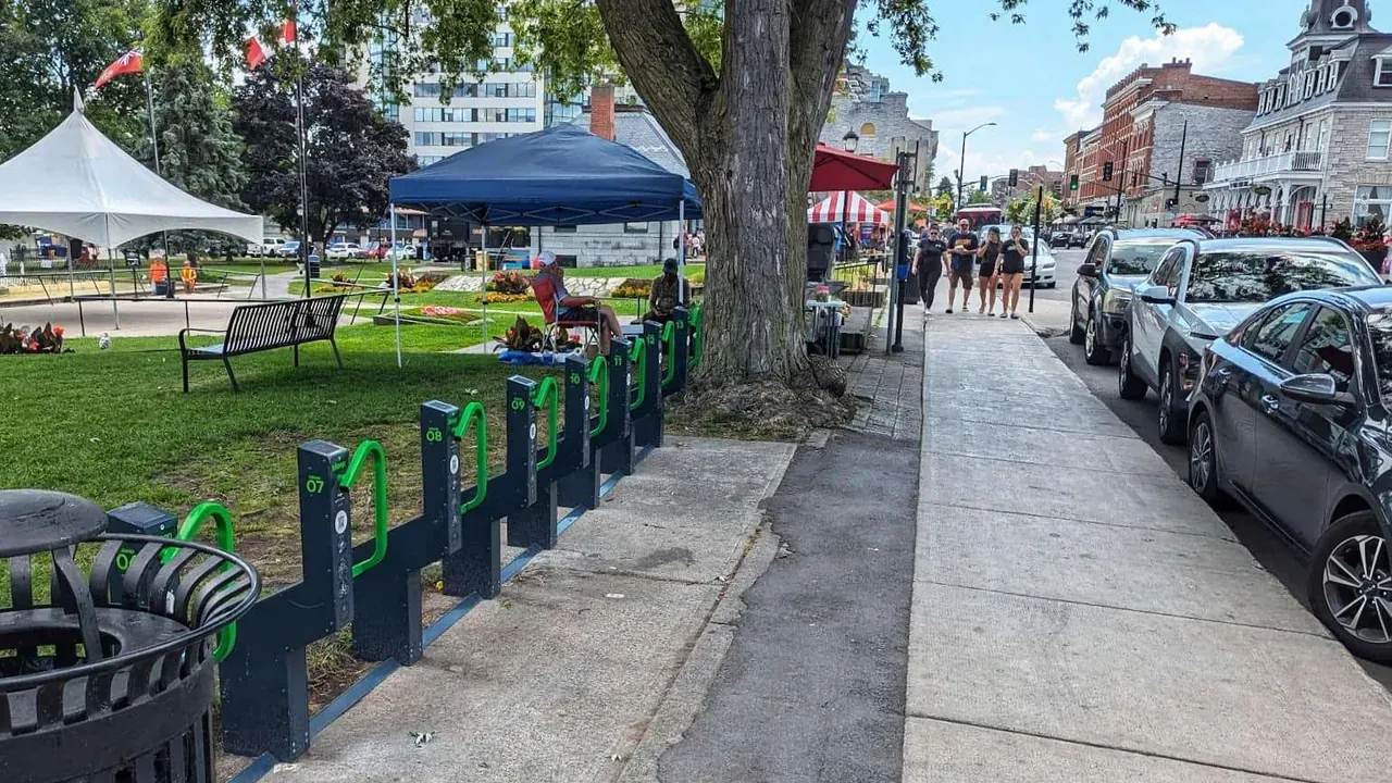Row of Bikeep secure bike parking docks in the park across from Kingston City Hall on Ontario Street