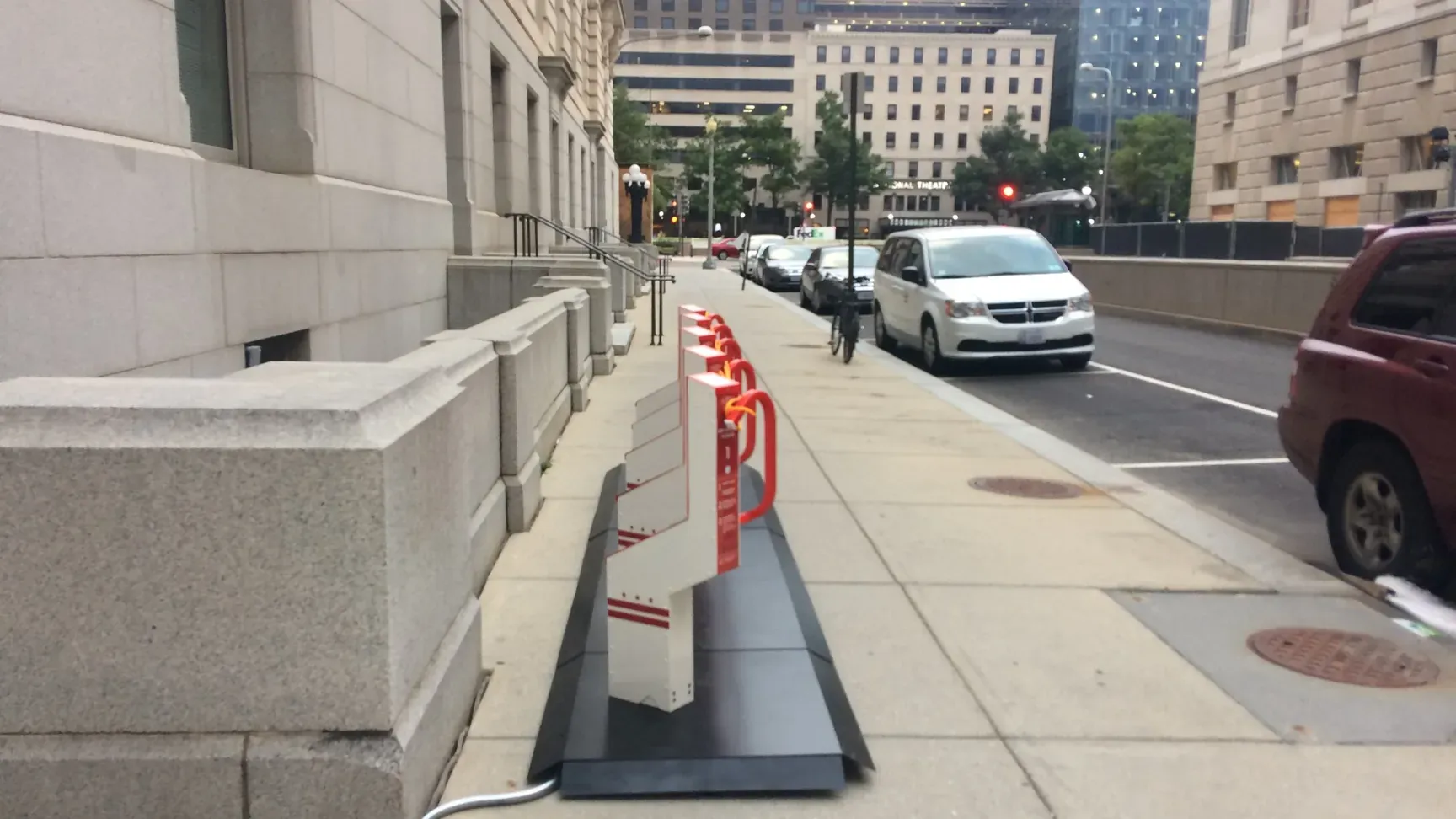 The 5-dock Bikeep station along the Wilson Building on 13½ Street NW, looking toward Pennsylvania Avenue and the National Theatre